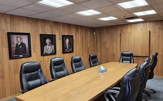 Boardroom with portraits on wood-panelled wall