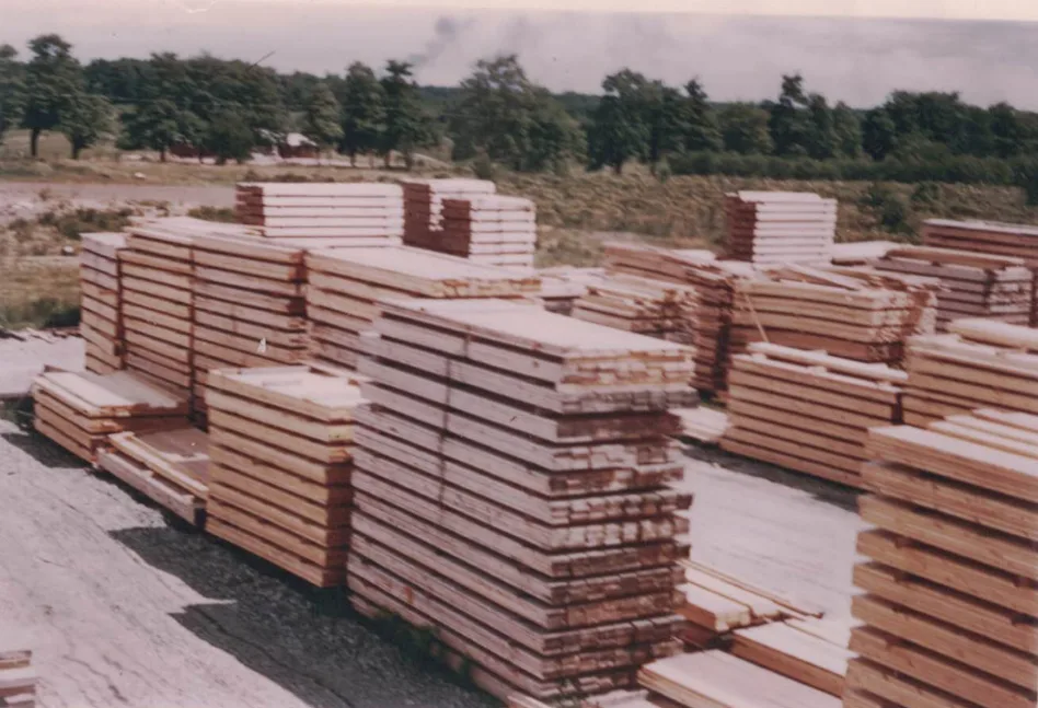 Archival photo of stacked lumber at the Alpa yard